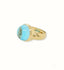 18k gold ring featuring a cabochon blue topaz gemstone.