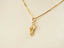 Gold flip flop pendant necklace with crystal accent in sparkling flip flop design