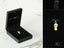 Gold skull-shaped charm in black jewelry box for Sparkling Flip Flop Pendant