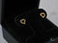 Gold heart-shaped stud earrings with sparkling cubic zirconia stones in 18k gold