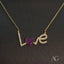 18k gold necklace with zirconia spelling "Love" featuring a sparkling heart, by Art Gold Jewelry.