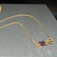 18k gold necklace with "Love" adorned with sparkling zirconia.