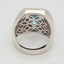 Swiss Blue Topaz Elegance Ring with 18k white gold band and intricate design, showcasing a vibrant blue gemstone and baguette diamonds.
