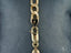 Gold-colored chain with lobster clasp on Timeless Love 18K Gold Figaro Bracelet
