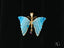 Delicate turquoise butterfly pendant with 18k yellow gold trim and purple crystal drop