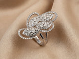 Angled view of 18K white gold diamond statement ring on champagne silk - ArtGold Jewelry