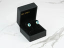 Azure Embrace earrings in black box with oval blue topaz gems