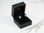 Black jewelry box with Azure Embrace earrings featuring oval blue topaz gemstones