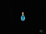 Azure Gleam blue topaz pendant in 14k gold with oval-cut gem