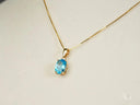 Azure Gleam blue topaz pendant in 14k gold chain necklace