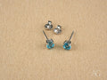 Azure Glow: 18k White Gold Blue Topaz Stud Earrings