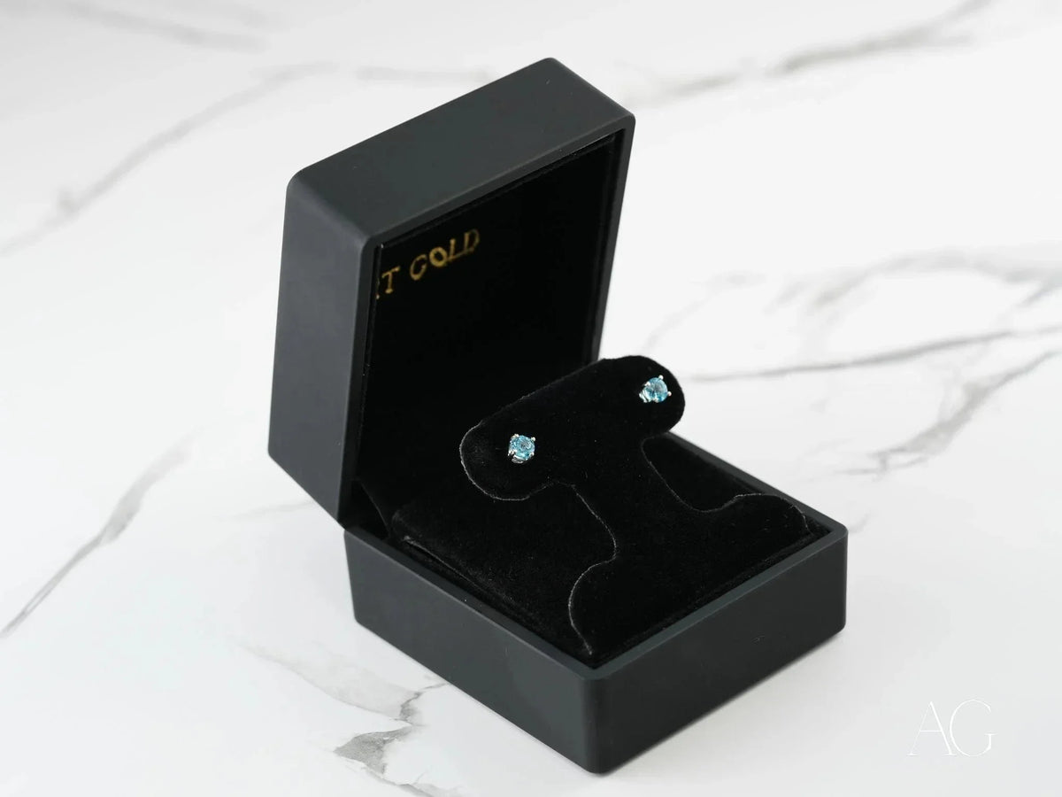 Azure Glow 18k white gold blue topaz stud earrings in black velvet box