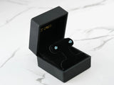 Azure Glow 18k white gold blue topaz stud earrings in black velvet box