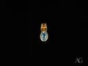 Azure Spark blue topaz pendant in 18k gold with oval-cut gemstone