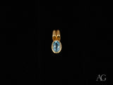 Azure Spark blue topaz pendant in 18k gold with oval-cut gemstone