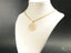 Gold-toned chain necklace with Blossom Spark flower pendant, an art gold jewelry piece