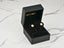 Gold CZ flower earrings from Blossom Sparkle in an open black jewelry box