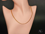 Delicate 18K gold chain necklace on mannequin