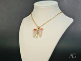 Butterfly Bliss topaz pendant: gold chain with pink and red-orange butterfly wings and blue gem