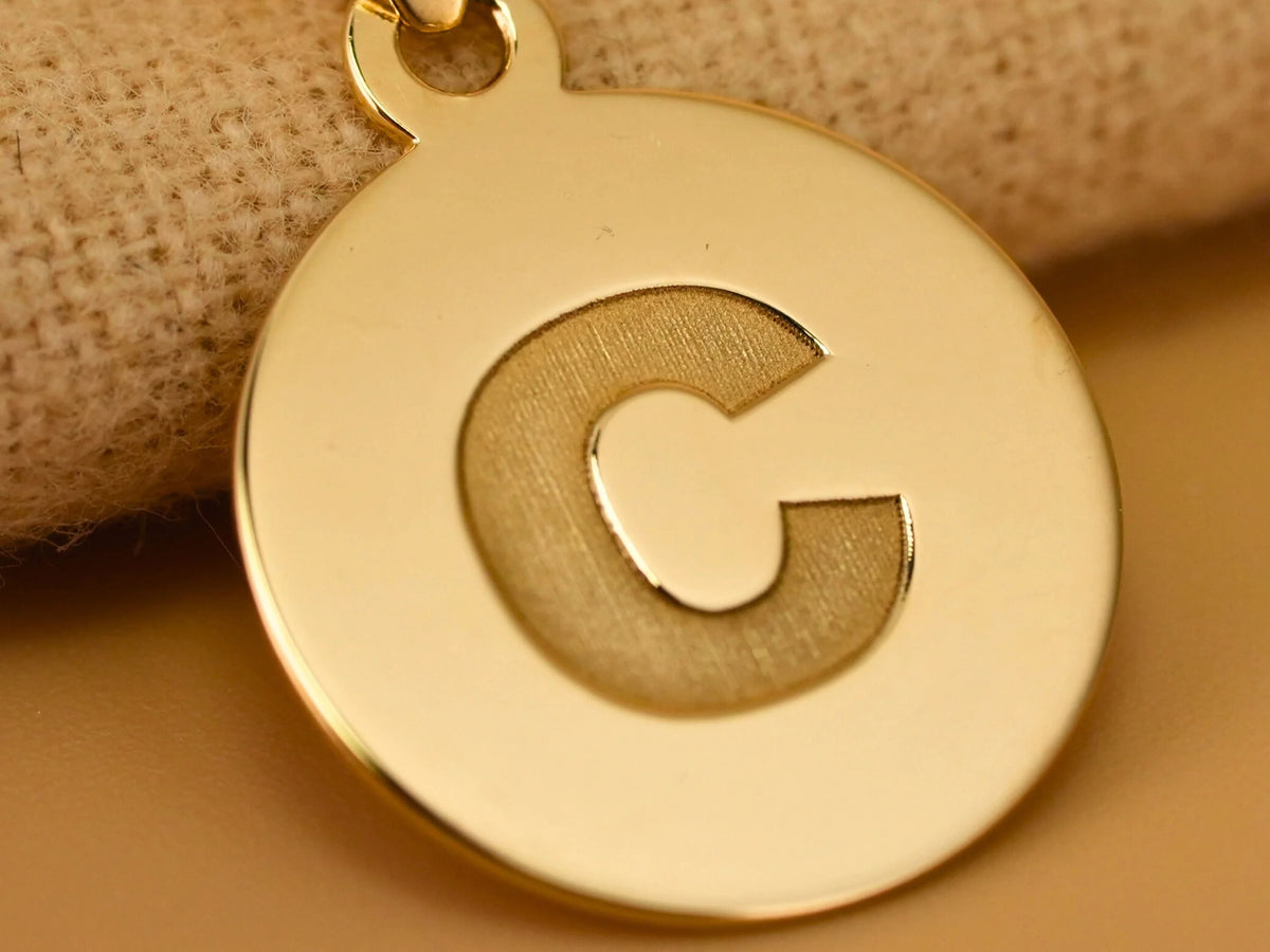 Shiny gold Celestia initial disc personalized pendant with engraved C