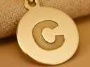 Shiny gold Celestia initial disc personalized pendant with engraved C