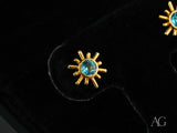 Celestial Glow 18k gold blue topaz stud earrings with sunburst design