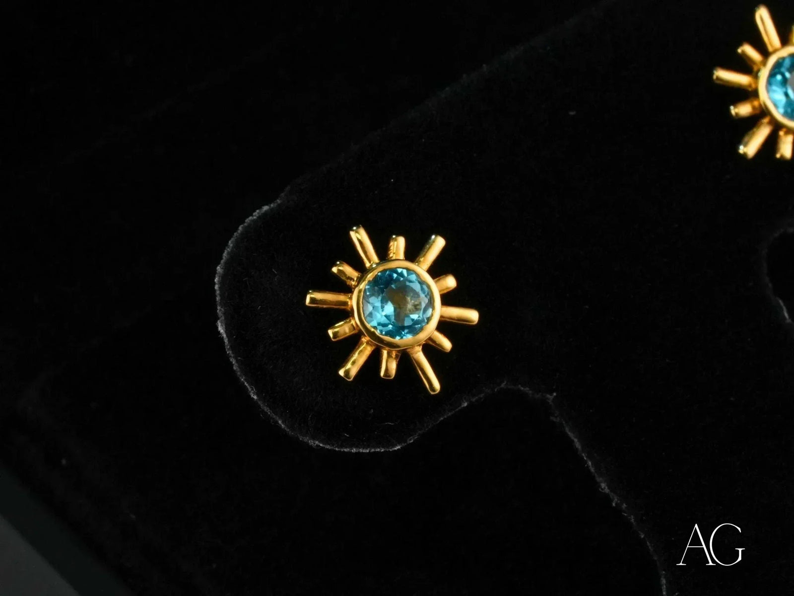 Celestial Glow 18k gold blue topaz stud earrings with sunburst design