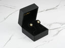 Open Celestial Glow 18k gold blue topaz stud earrings in black box