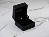 Black velvet box displays Celestial Glow 18k gold star earrings