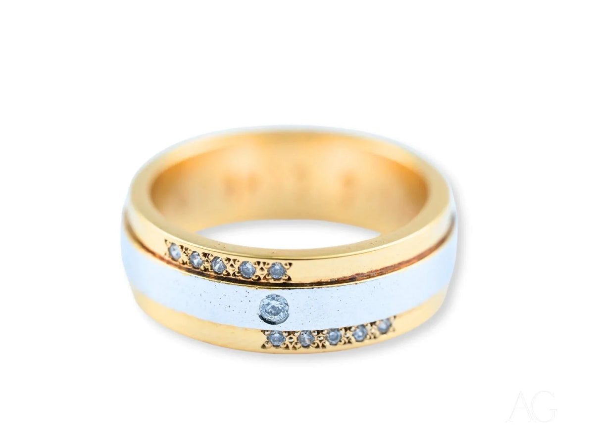 Two-tone gold wedding band with diamond accents, angled view showing band profile