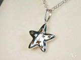 Celestial Radiance 18k white gold star pendant with shiny silver cut-outs
