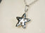 Shiny silver star pendant with cut-out designs from Celestial Radiance art gold jewelry collection in 18k white gold