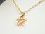 Celestial Smoke crystal star pendant in gold jewelry featuring faceted peach-orange crystal