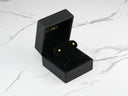 Celestial Spark 18k gold star CZ kids earrings in black jewelry box