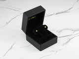 Celestial Spark 18k gold star CZ kids earrings in black jewelry box