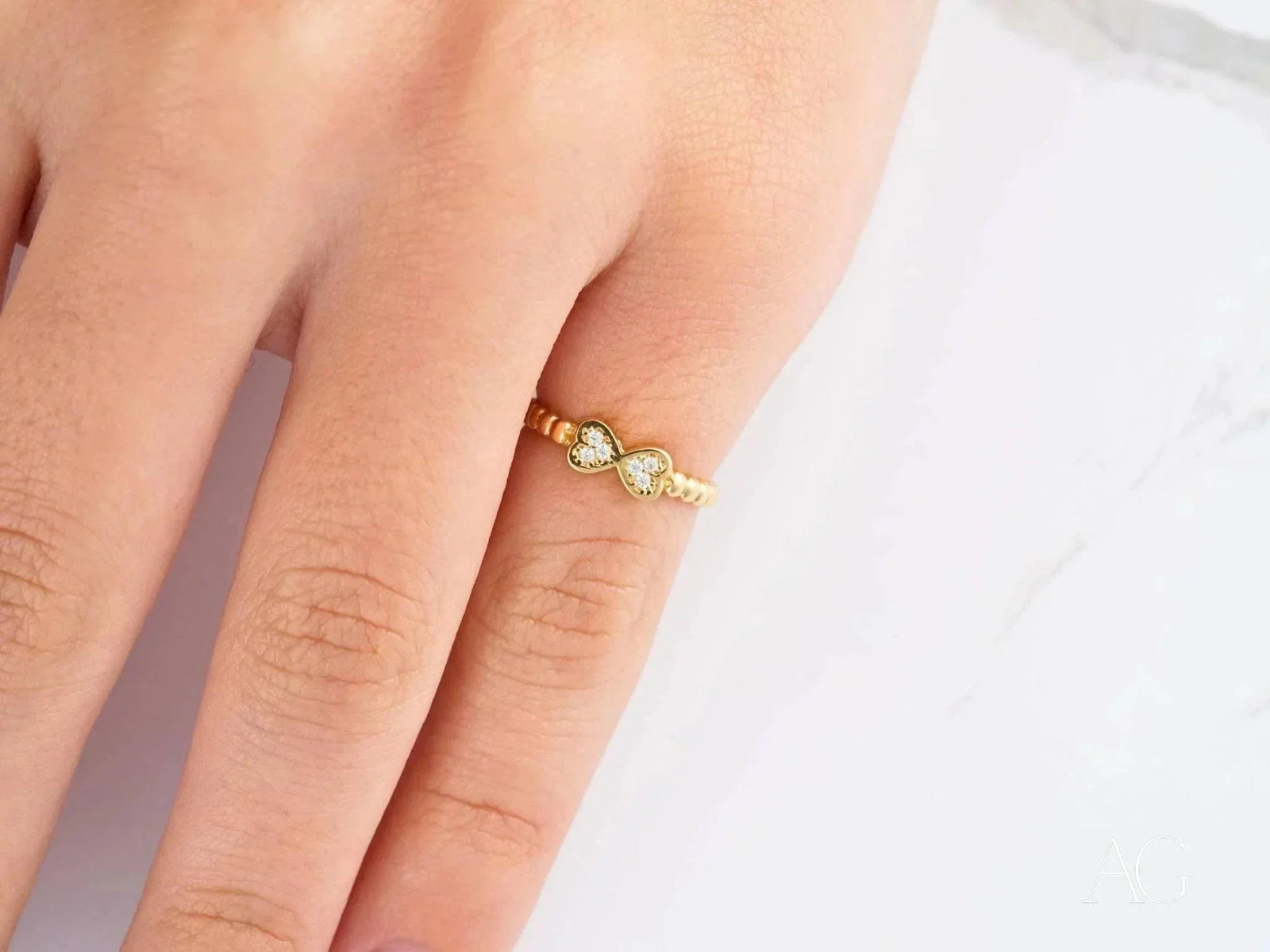 Charming 18k yellow gold bow CZ ring with heart-shaped diamonds