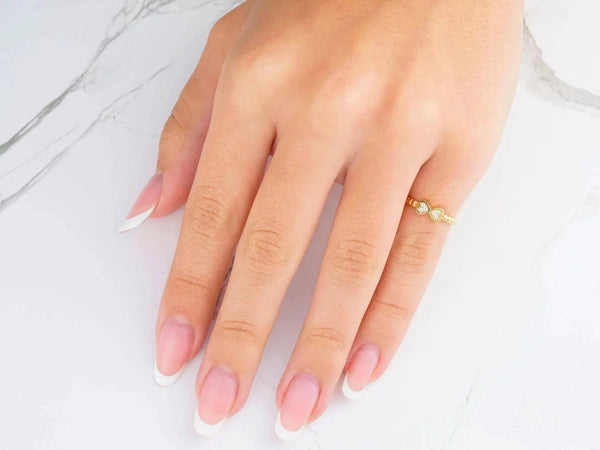 Dainty 18k yellow gold bow CZ ring with light-colored stones