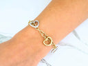 18k yellow and white gold heart link bracelet on wrist
