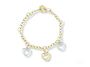 Enchanting bracelet combines 18k yellow and white gold with three heart charms