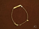 Personalized gold ID bracelet with heart motif and lobster lock