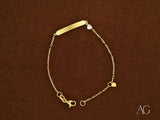 Personalized gold ID bracelet with heart motif and lobster lock
