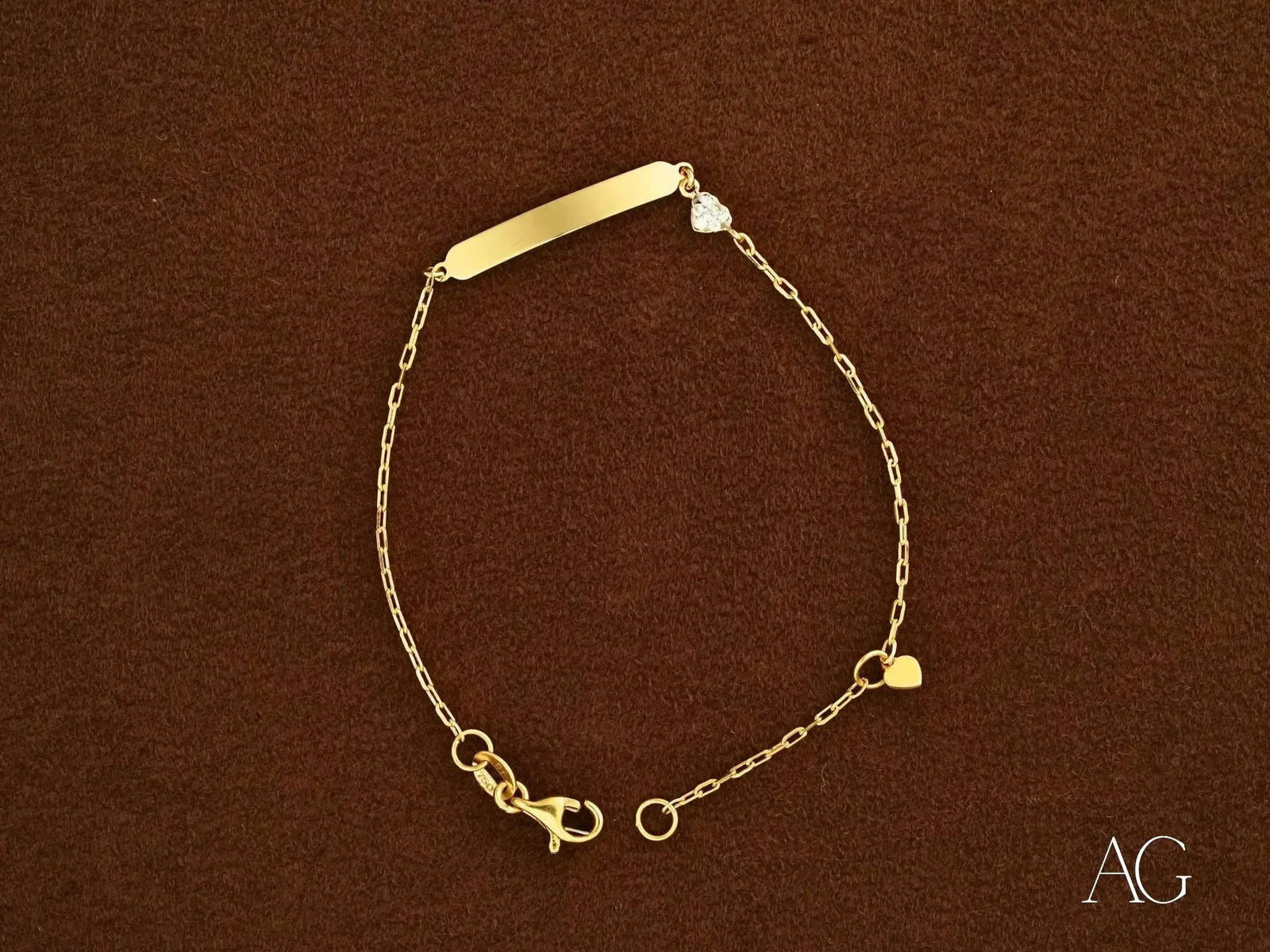 Personalized gold ID bracelet with heart motif and lobster lock