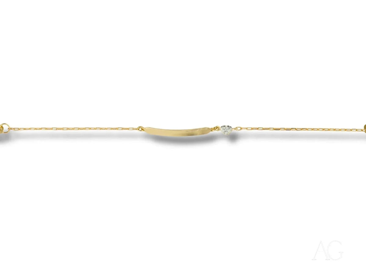 Delicate gold ID bracelet with heart motif, curved bar, clear gem, lobster lock