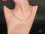 Delicate 18K gold chain necklace on mannequin, art gold jewelry