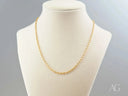 Delicate 18K gold chain necklace on cream mannequin