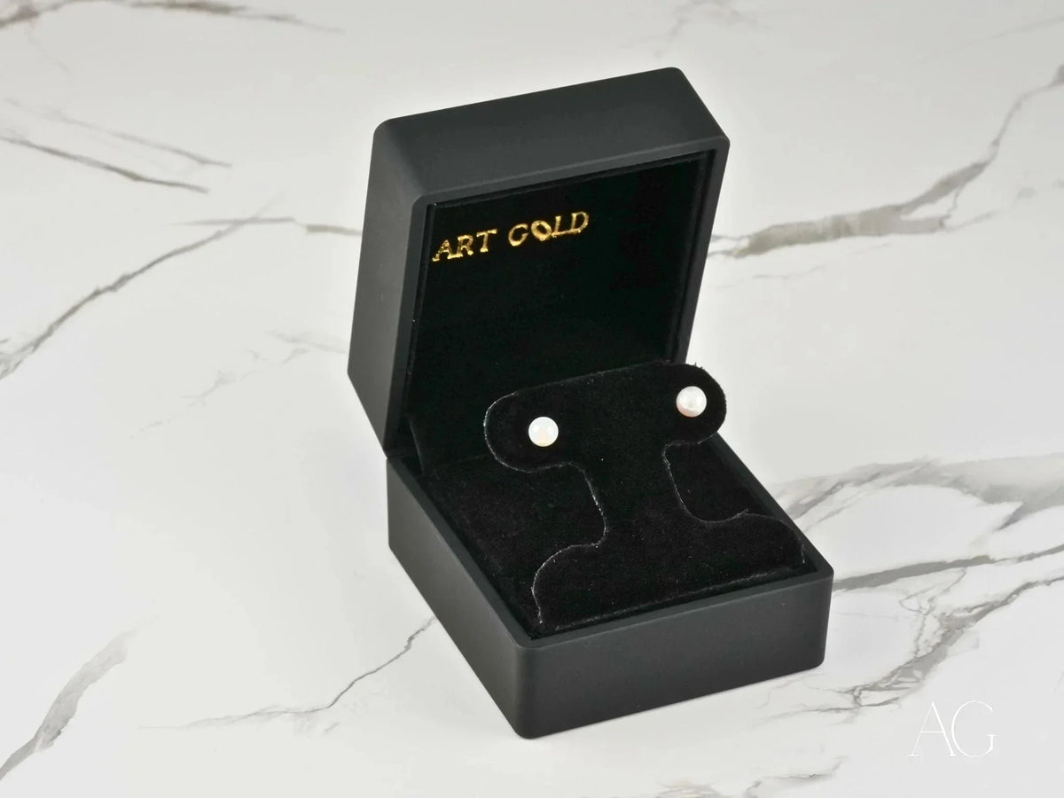 Classic Lustre 18K gold pearl stud earrings in black velvet box