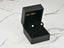 Black jewelry box with classic lustre 18K gold pearl stud earrings on velvet insert