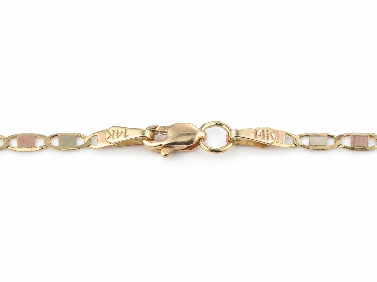 Lobster claw clasp on the 14K gold piastrine chain, both oval end tags stamped 14K