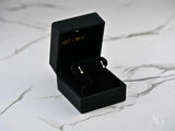 Cupid’s Arrow 18k gold CZ arrow stud earrings in black box with push-back clasp