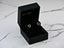 Pair of heart earrings with cubic zirconia stones in a black jewelry box, elegance meets romance